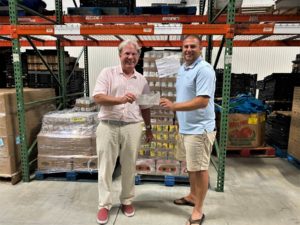 Dudley Patteson of the Dog and Oyster Vineyard presents check to Mark Kleinschmidt of Healthy Harvest Food Bank